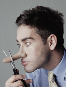 Young man cutting nose with scissors, side view, close-up